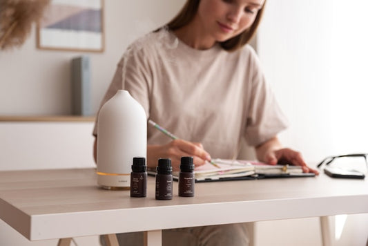 Create an image of a serene and inviting room with a diffuser in the center, emitting a soft, calming mist of essential oils. Surrounding the diffuser are various bottles of essential oils, each label